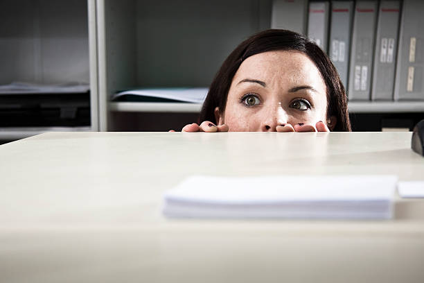 Young businesswoman overcome by fear in an office.